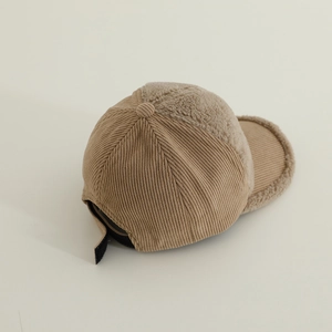 Detail of brown corduroy and soft white sherpa fleece拼接 on a children's baseball cap
