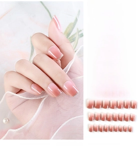 Detailed set of 24 pieces of pink gradient press-on nails with golden glitter tips