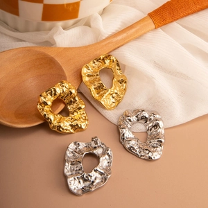 Irregular textured hoop earrings with hammered metal finish in gold and silver plating