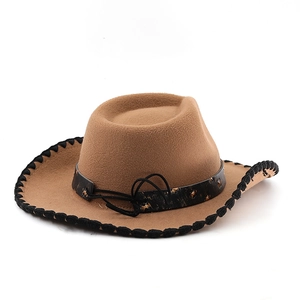 Detail of camel western cowboy hat with black whipstitched brim and studded band decor