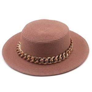 Chic magenta flat top straw boater hat with a bold gold chain link for beach sun protection