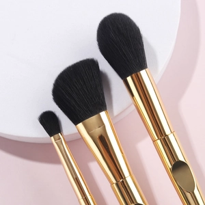 Three-piece professional gold makeup brush set with dense black synthetic bristles