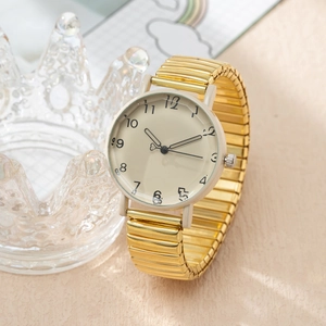 Detail of gold elastic band quartz watch with cream dial and black numerals