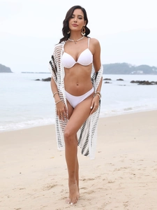 Detail of crochet knit beach cover-up featuring black contrast stripes and texture
