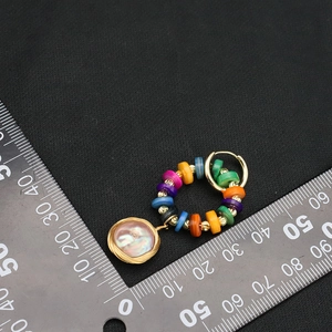 Handmade colorful beaded hoop earrings with a gold metal ring and pearl drop pendant