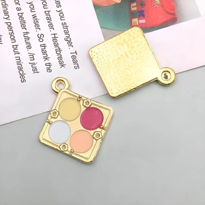 Detail of square alloy charm with four-color enamel makeup palette and hammered back