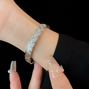 Detailed view of silver quilted zircon bangle with luxury cross pattern for women