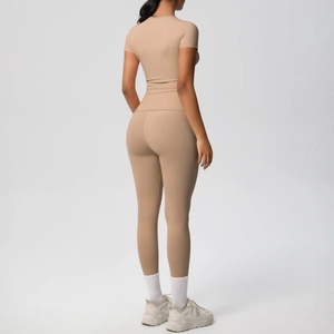 Back view of a woman in a seamless nude yoga set with high waist leggings and a slim t-shirt