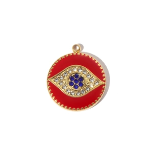 Macro detail of red enamel Evil Eye pendant in gold stainless steel with rhinestones