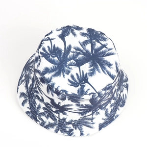 Top view of white bucket hat with blue palm leaf patterns and durable cotton fabric
