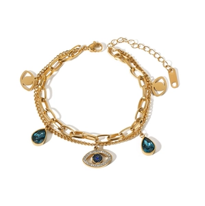 Detail of gold-plated double-layer bracelet with blue evil eye charms and crystals