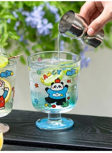 Gros plan d'un verre à vin panda avec glaçons et raisin sous une lumière naturelle