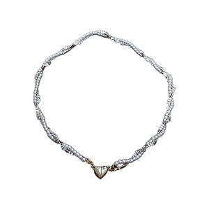 Minimalist pearl wrap necklace with a silver heart magnetic clasp on white background