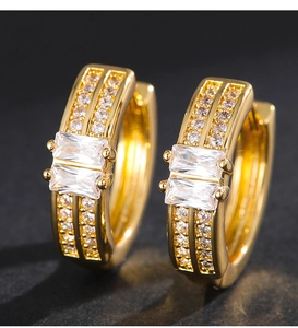 Macro shot of gold hoop earrings featuring rectangular zircons and micro-pave crystals