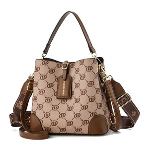 Brown vintage canvas bucket bag with monogram pattern and stylish wide shoulder strap