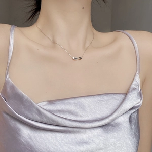 Minimalist 925 sterling silver necklace with a twisted geometric bar pendant on model