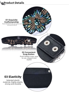 Detail of black elastic belt featuring handcrafted beaded floral rhinestones and metal snaps