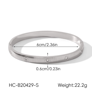 Detail view of silver stainless steel striped bangle with dimensions and diamond inlay