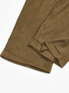 Close-up of brown corduroy fabric texture and stitching details on men's vintage pants
