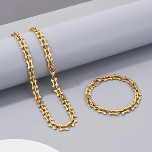 Detail of gold titanium steel necklace with creative hollow bone-shaped chain links
