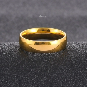 Macro shot of 6mm polished gold titanium ring highlighting the smooth metallic surface