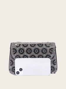 Black rhinestone clutch bag shown next to a smartphone for clear size comparison