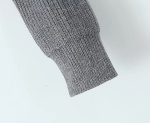 Detail of grey rib-knit cuff on a stylish American letter patterned cardigan sweater