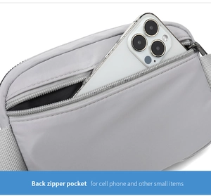 Close-up of the back zipper pocket on the waterproof nylon bag holding a smartphone