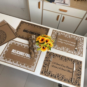 Brown rectangular woven placemats with vintage screen print text in a set of four