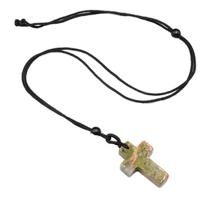 Natural Unakite stone cross pendant necklace with adjustable black braided cord on white background