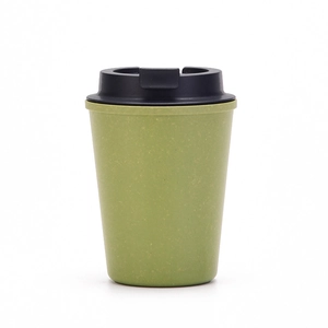 Detail view of eco-friendly wheat straw coffee cup with matte green texture and black lid
