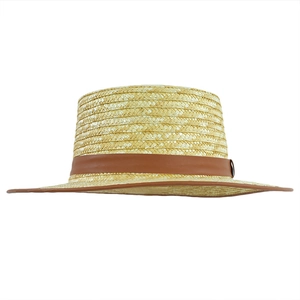 Detailed view of the fine straw weave and brown faux leather trim on a classic boater hat