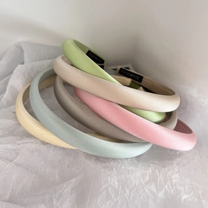 Minimalist satin silk headbands in five colors with handmade tags on white paper background