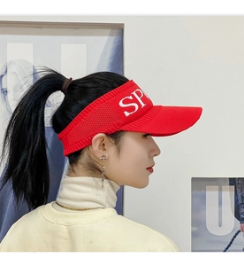 Detail view of red sun visor hat featuring breathable knit fabric and SPORT embroidery