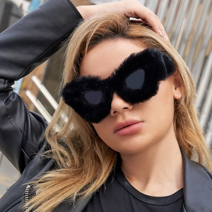 Detail of plush black faux fur trim on stylish cat eye oversized winter sunglasses for women