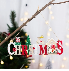 Dettaglio di un cartello natalizio in legno con renne e Babbo Natale su sfondo caldo