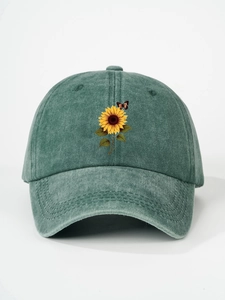 Close-up of vintage washed green cotton baseball cap with printed sunflower and butterfly
