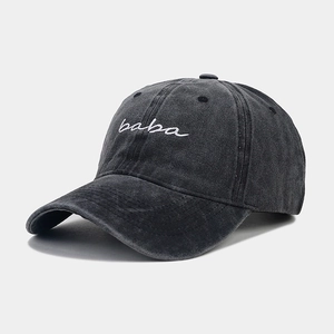 Close-up of charcoal grey washed cotton baseball cap with white baba embroidery detail