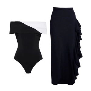 Chic black and white V-neck monokini paired with a matching side-ruffle maxi skirt set