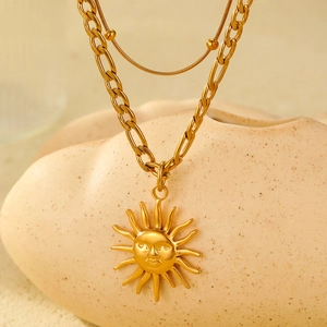 Chunky gold horseshoe chain with sun god pendant and layered snake chain necklace