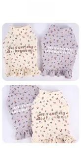 Close-up of floral pet sweatshirt with ruffle hem and embroidered slogan for small dogs