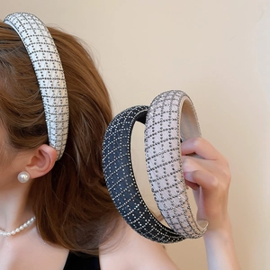 Detail of padded fabric headbands with sparkling rhinestones in black, white, and pink