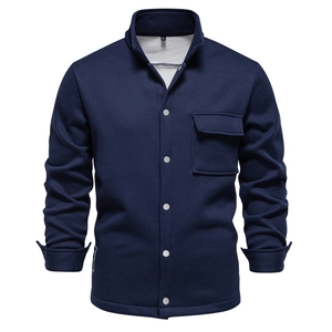 Close-up of navy blue waffle knit cardigan jacket featuring silver buttons and chest pocket