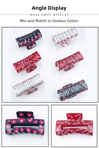 Detail of glitter acrylic claw clips with romantic heart and cupid patterns
