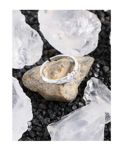 Detail showing the S925 hallmark and hammered texture on the silver star ring