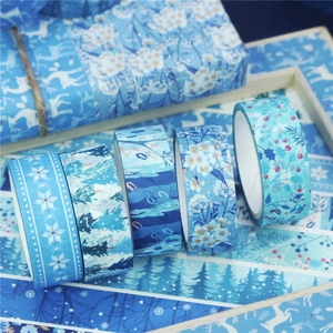 Detailed view of blue winter washi tape set featuring snowflakes and forest patterns