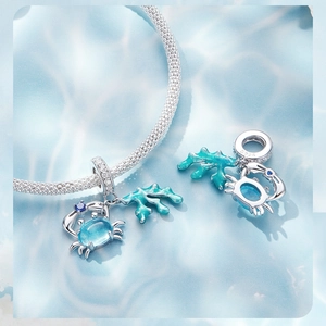 Detailed view of S925 sterling silver crab and coral pendant with blue gemstones
