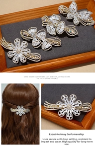 Detailed close-up of sparkling crystal butterfly and floral hair clips on gold alloy