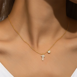 Detail of 925 silver gold flower cross pendant necklace with zircon on a model