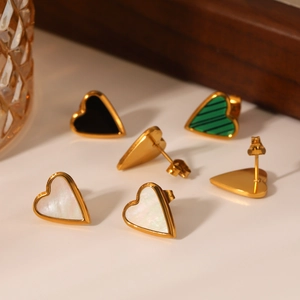 Detail of heart stud earrings with white shell, black onyx, and green malachite inlays